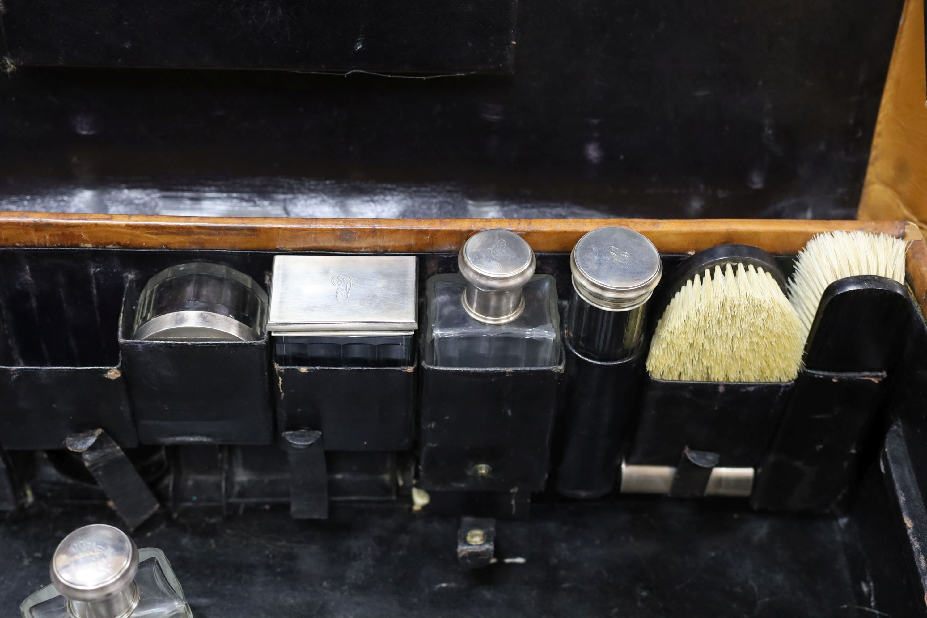A Dupont travel suitcase, initialled ‘L.C.’ with French white metal mounted bottles